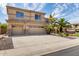 Charming two-story home showcasing a well-manicured front yard with lush landscaping and a three-car garage at 2302 S Canfield --, Mesa, AZ 85209