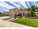 Beautiful two-story home featuring a well-maintained lawn, desert landscaping, and a spacious three-car garage at 2302 S Canfield --, Mesa, AZ 85209