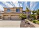 Charming two-story home showcasing a well-manicured front yard with lush landscaping and a three-car garage at 2302 S Canfield --, Mesa, AZ 85209