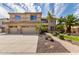 Charming two-story home showcasing a well-manicured front yard with lush landscaping and a three-car garage at 2302 S Canfield --, Mesa, AZ 85209