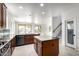Bright kitchen with an island, a pantry, and views of the backyard and pool at 2302 S Canfield --, Mesa, AZ 85209