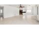 Large living room open to kitchen with ceiling fan and neutral tile flooring at 2302 S Canfield --, Mesa, AZ 85209