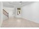 Spacious living room featuring staircase, neutral tile flooring and natural light at 2302 S Canfield --, Mesa, AZ 85209