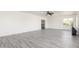 Spacious living room with large windows, neutral walls, and gray wood-look flooring providing ample natural light at 2302 S Canfield --, Mesa, AZ 85209