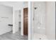 Elegant main bathroom with glass enclosed shower, linen closet, and vanity area at 2302 S Canfield --, Mesa, AZ 85209