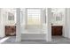 Bright main bathroom showcases soaking tub, white columns, and & vanities at 2302 S Canfield --, Mesa, AZ 85209