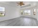 Bright main bedroom features wood grain floors, large windows, and unique ceiling fan at 2302 S Canfield --, Mesa, AZ 85209