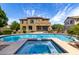 Backyard showcasing a sparkling pool and spa with a basketball hoop and covered patio of a two-story home at 2302 S Canfield --, Mesa, AZ 85209