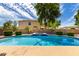 Large swimming pool and spa with blue tile surrounded by lush landscaping and a privacy fence at 2302 S Canfield --, Mesa, AZ 85209