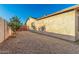 Backyard area includes xeriscaping, small tree, window view, and wooden fence at 2419 E Billings St, Mesa, AZ 85213