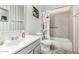 Bathroom with white vanity, white tiled walls and tub with shower at 2419 E Billings St, Mesa, AZ 85213