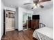 Bedroom features wood-look flooring, modern ceiling fan, dresser with mirror and tv at 2419 E Billings St, Mesa, AZ 85213