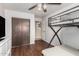 This bedroom features a ceiling fan, closet, doorway, and bunk beds with wood laminate flooring at 2419 E Billings St, Mesa, AZ 85213