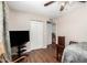 This bedroom includes a ceiling fan, wood-look flooring, and closet at 2419 E Billings St, Mesa, AZ 85213