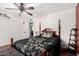 Bedroom featuring ceiling fan, wood floors and a four poster bed at 2419 E Billings St, Mesa, AZ 85213