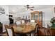 Dining room with wood floors, an antique hutch and view into the kitchen and living spaces at 2419 E Billings St, Mesa, AZ 85213