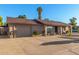 Single-level home featuring an attached garage with an expansive driveway for easy access and extra parking at 2419 E Billings St, Mesa, AZ 85213