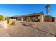 Single-level home displaying xeriscape landscaping with well-manicured shrubs and gravel in the front yard at 2419 E Billings St, Mesa, AZ 85213