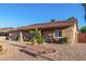 Charming single-story home featuring desert landscaping and covered front porch seating at 2419 E Billings St, Mesa, AZ 85213