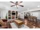 Open-concept living room featuring built-in shelving and views to the dining and kitchen area with wood-look floors at 2419 E Billings St, Mesa, AZ 85213