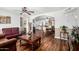 Spacious living room with wood floors, traditional furnishings, and an open layout to the kitchen and dining areas at 2419 E Billings St, Mesa, AZ 85213