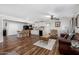 Open-concept space with wood floors, an island with seating, and views to the kitchen at 2419 E Billings St, Mesa, AZ 85213