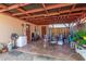 Covered patio area features outdoor seating, fan and decorative lighting at 2419 E Billings St, Mesa, AZ 85213
