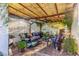 Covered patio with outdoor seating, dining, greenery, and a fountain at 2419 E Billings St, Mesa, AZ 85213