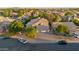 Aerial image displays the house and neighborhood surrounded by mature trees and street views at 249 E Palomino Ct, Gilbert, AZ 85296