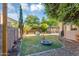 Expansive backyard features lush greenery, play area, and a relaxing gazebo for outdoor enjoyment at 249 E Palomino Ct, Gilbert, AZ 85296