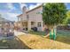 Spacious backyard with a patio, play equipment, and ample room for outdoor activities and relaxation at 249 E Palomino Ct, Gilbert, AZ 85296