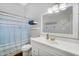 Bathroom featuring a bathtub with shower curtain and vanity sink with large mirror at 249 E Palomino Ct, Gilbert, AZ 85296