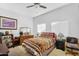 Cozy bedroom with southwestern style bedspread, ceiling fan, and natural light at 249 E Palomino Ct, Gilbert, AZ 85296