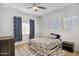 Cozy bedroom with blue patterned bedspread, ceiling fan, and natural light at 249 E Palomino Ct, Gilbert, AZ 85296