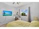 Bright bedroom with desk, large window with view, and a ceiling fan at 249 E Palomino Ct, Gilbert, AZ 85296