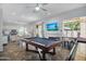 Spacious game room featuring a pool table, adjacent to the kitchen and dining areas at 249 E Palomino Ct, Gilbert, AZ 85296
