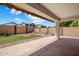 Charming covered patio area with beautiful backyard featuring rock features, manicured artificial grass, and privacy walls at 2615 W Silver Streak Way, San Tan Valley, AZ 85144