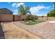 Private backyard offering a horseshoe pit, artificial turf, landscaping, and brick accents; perfect for outdoor activities at 2615 W Silver Streak Way, San Tan Valley, AZ 85144