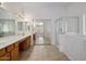 Bathroom showcasing a walk-in shower, large tub, and dual sinks beneath a wide mirror at 2615 W Silver Streak Way, San Tan Valley, AZ 85144