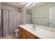 Bathroom featuring a toilet, sink, shower with curtain and large mirror above the sink at 2615 W Silver Streak Way, San Tan Valley, AZ 85144