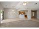 Open-concept living room featuring neutral paint, tile flooring, and ample natural light at 2615 W Silver Streak Way, San Tan Valley, AZ 85144