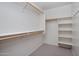 Organized walk-in closet with shelves and wooden rods for plentiful storage opportunities at 2615 W Silver Streak Way, San Tan Valley, AZ 85144