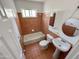 Bright bathroom with a bathtub, tiled walls, a vanity, and a window at 2928 N 37Th Ave, Phoenix, AZ 85019