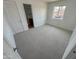 Clean, carpeted bedroom with a window and neutral walls; ensuite bath at 2928 N 37Th Ave, Phoenix, AZ 85019