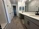 Bathroom featuring double sinks, white quartz countertops, black fixtures, and tile flooring at 32661 N Newby Dr, San Tan Valley, AZ 85143