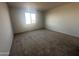 Inviting bedroom with neutral carpet and ample natural light from a large window at 32661 N Newby Dr, San Tan Valley, AZ 85143