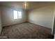 Inviting bedroom with neutral carpet and a bright window at 32661 N Newby Dr, San Tan Valley, AZ 85143