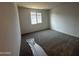 A bedroom with carpet and a large window at 32661 N Newby Dr, San Tan Valley, AZ 85143