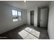 Well-lit bedroom with ample closet space, large window, and neutral carpeting at 32661 N Newby Dr, San Tan Valley, AZ 85143