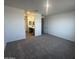 This bedroom features carpet flooring, access to the bathroom, and an abundance of natural light at 32661 N Newby Dr, San Tan Valley, AZ 85143